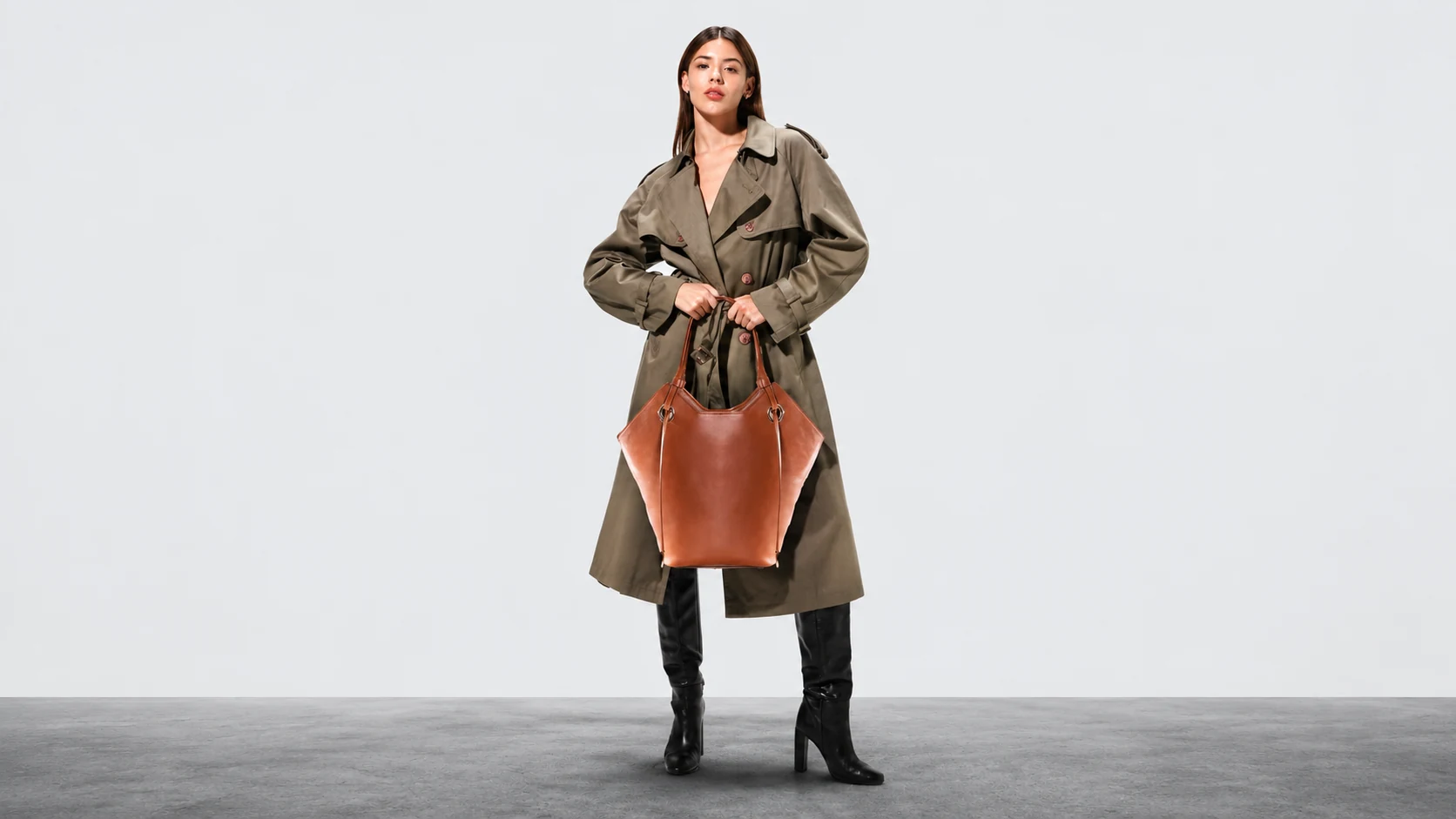 A woman carrying a brown leather OOWNE tote bag